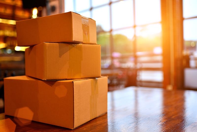 A stack of three boxes on a wooden table. 